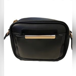Black purse with double zipper and phone pouch in the front.